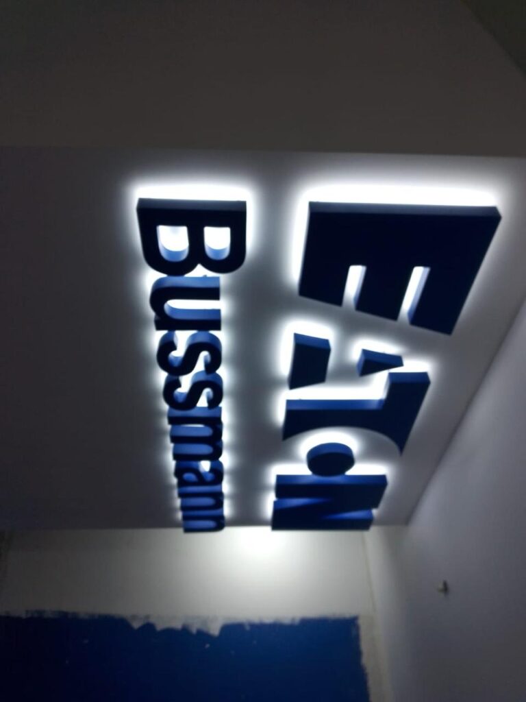 Letreros Bussmann y Eaton en letras azules retroiluminadas instalados en esquina interior